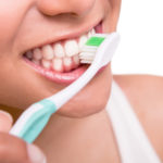 Woman holding a tooth brush